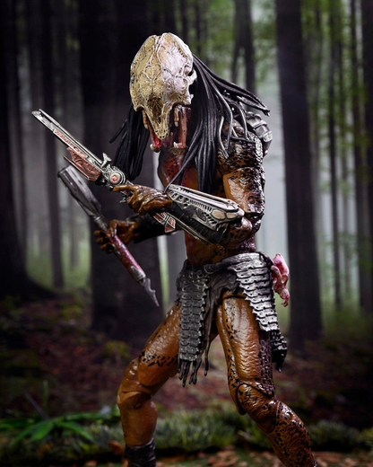 VaultifyUK NECA Prey Feral Predator 7-inch action figure with detailed bone mask and tribal armor in a forest setting