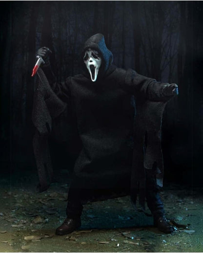 VaultifyUK NECA Ghost Face action figure from Scream wearing a black fabric robe and holding a bloody knife in a forest