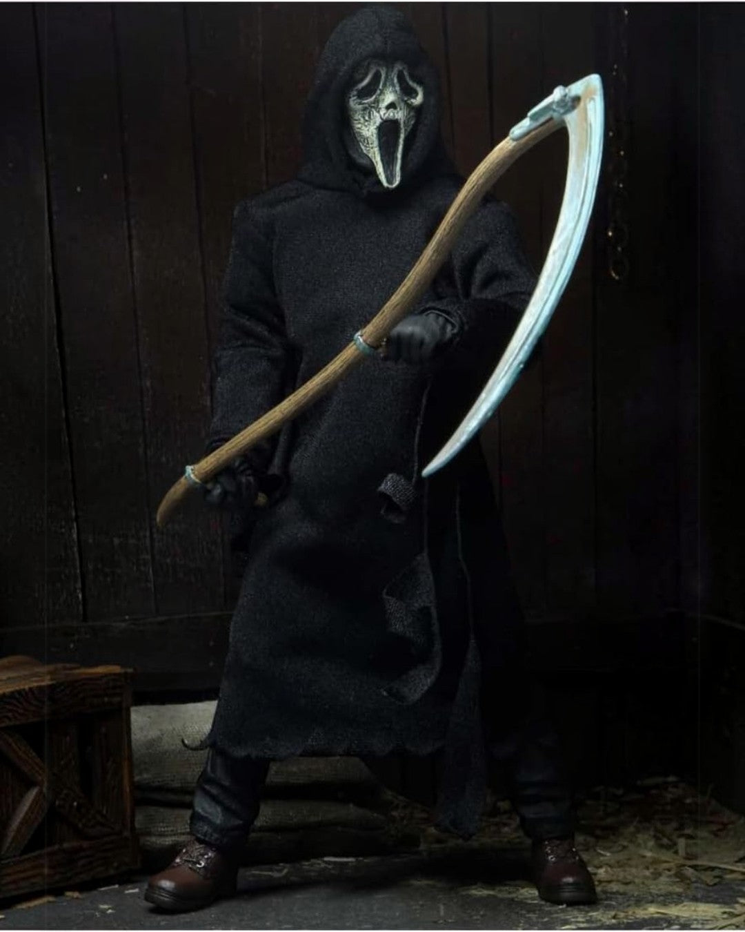 VaultifyUK NECA Ghost Face action figure wearing a black fabric robe and holding a large scythe in a dark setting