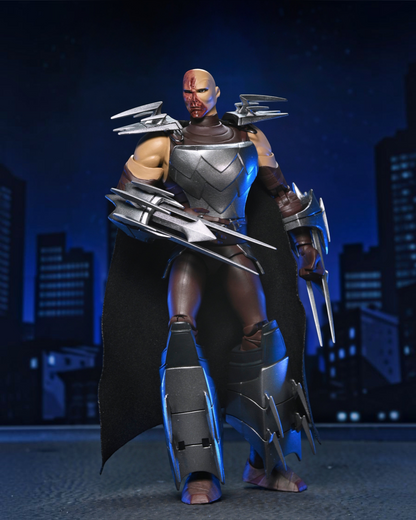 VaultifyUK NECA TMNT 2012 Shredder action figure with battle-damaged face, silver armor, and removable fabric cape.