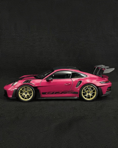 VaultifyUK Schuco 1:18 scale Porsche 911 GT3 RS model car in Rubystar magenta with gold wheels, side profile view.