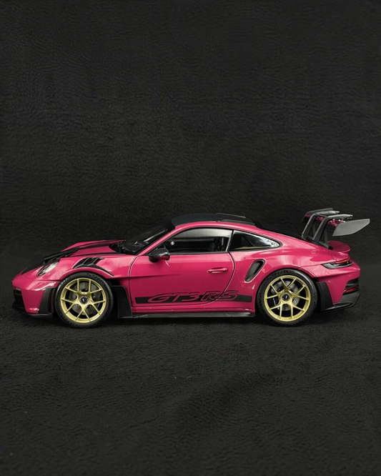 VaultifyUK Schuco 1:18 scale Porsche 911 GT3 RS model car in Rubystar magenta with gold wheels, side profile view.