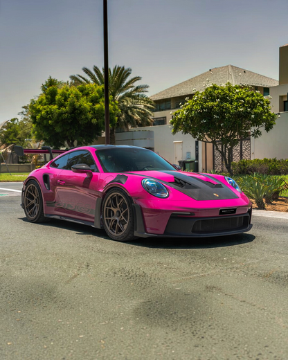 VaultifyUK Schuco 1:18 scale Porsche 911 992 GT3 RS model car in vibrant Rubystar magenta parked on a sunny street