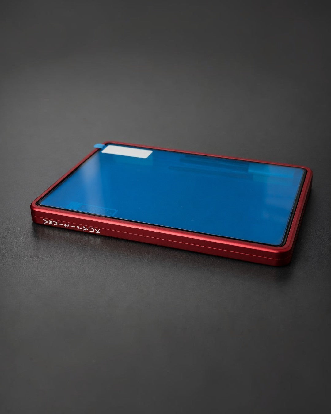 VaultifyUK Showcase red aluminium BGS slab display case with a protective blue film on the clear viewing panel