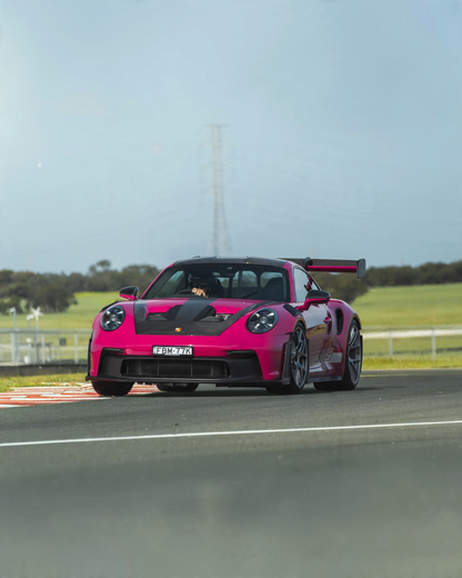 VaultifyUK Schuco 1:18 scale Porsche 911 GT3 RS model in Rubystar magenta driving on a race track