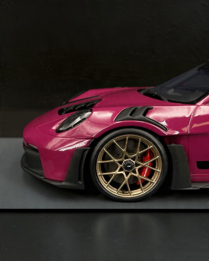 VaultifyUK Schuco 1:18 scale Porsche 911 GT3 RS model car in Rubystar magenta with gold wheels and red brake calipers.