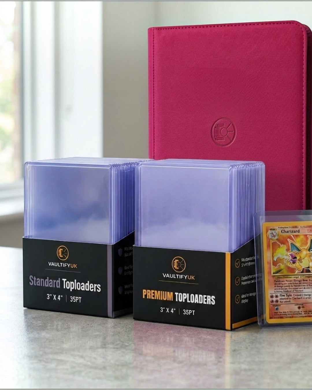 VaultifyUK Shield standard and premium 35PT toploader packs with a trading card and red binder on a table.