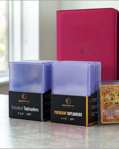VaultifyUK Shield standard and premium 35PT toploader packs with a trading card and red binder on a table.