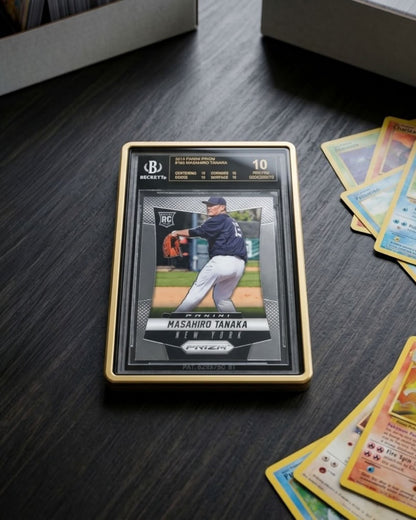 VaultifyUK Showcase gold aluminium display case protecting a graded BGS card on a dark wooden desk with magnifying glasses