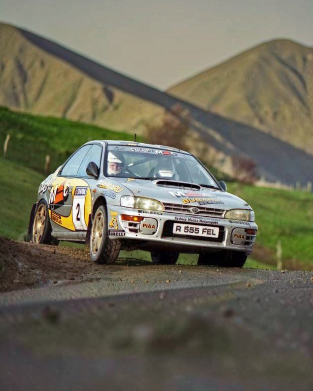 VaultifyUK 1:18 scale silver and yellow Subaru Impreza 555 rally car driven by Fisher and Kennedy in 1999