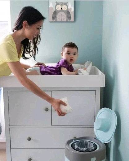 VaultifyUK mother disposing of a nappy in a Tommee Tippee Twist & Click bin with antibacterial refill cassette