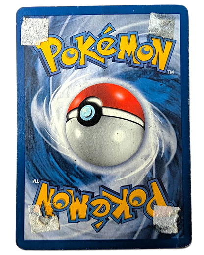 Reverse side of a damaged VaultifyUK 1999 Jungle set Wigglytuff Pokémon card showing adhesive residue and paper tears.